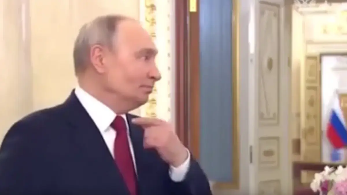 Putin gestured to his throat during the speech. Credit: Kremlin