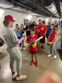The young boy a signed bat from Harrison Bader after the game. Credit: X/Philadelphia Phillies
