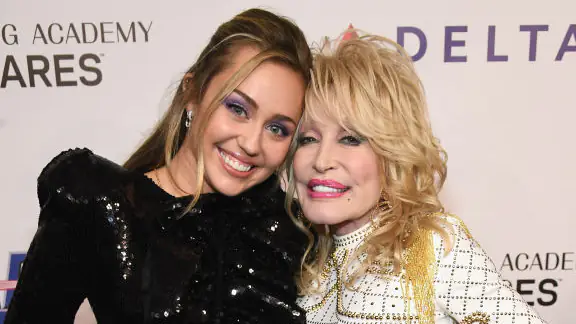 LOS ANGELES, CA - FEBRUARY 08: Miley Cyrus (L) and Dolly Parton attend MusiCares Person of the Year honoring Dolly Parton at Los Angeles Convention Center on February 8, 2019 in Los Angeles, California. (Photo by Kevin Mazur/Getty Images for The Recording Academy)