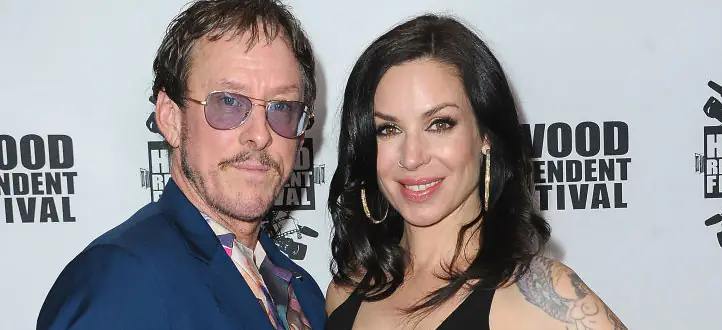 Rock star's wife is shot by cops and booked for attempted murder after 'interfering in police chase'