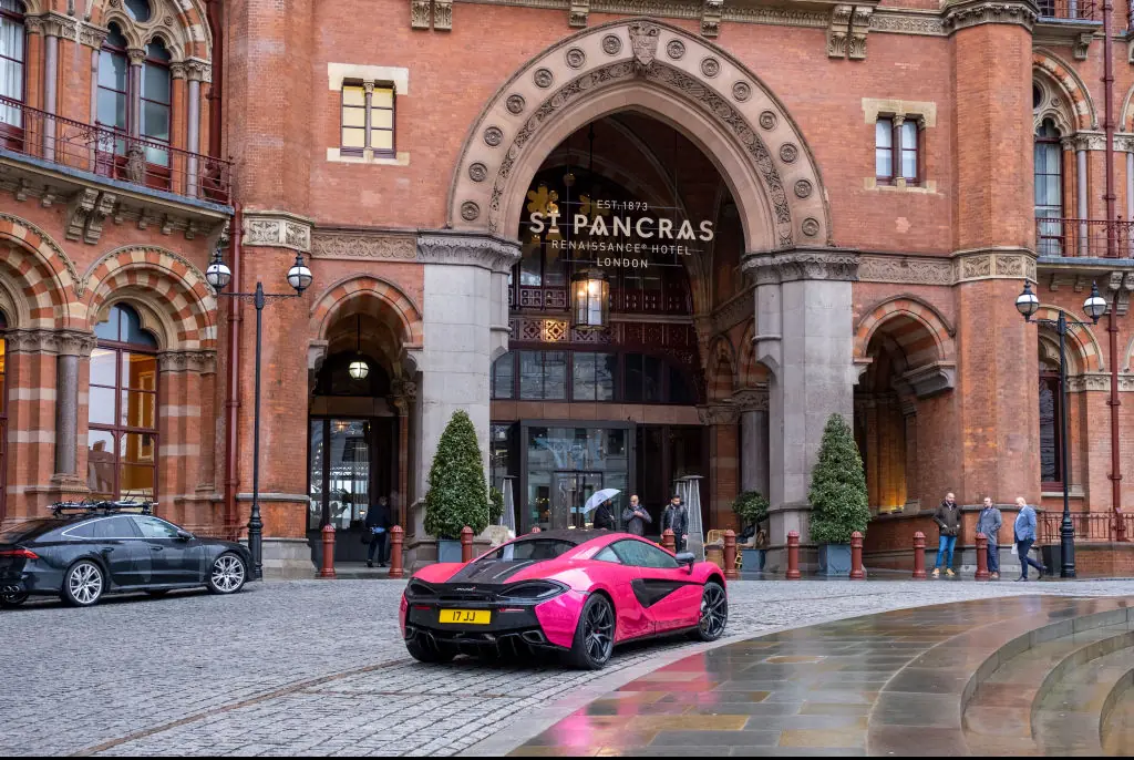 A pink McLaren 540c parked outside St Pancras Renaissance Hotel. Credit: Andrew Aitchison / Getty