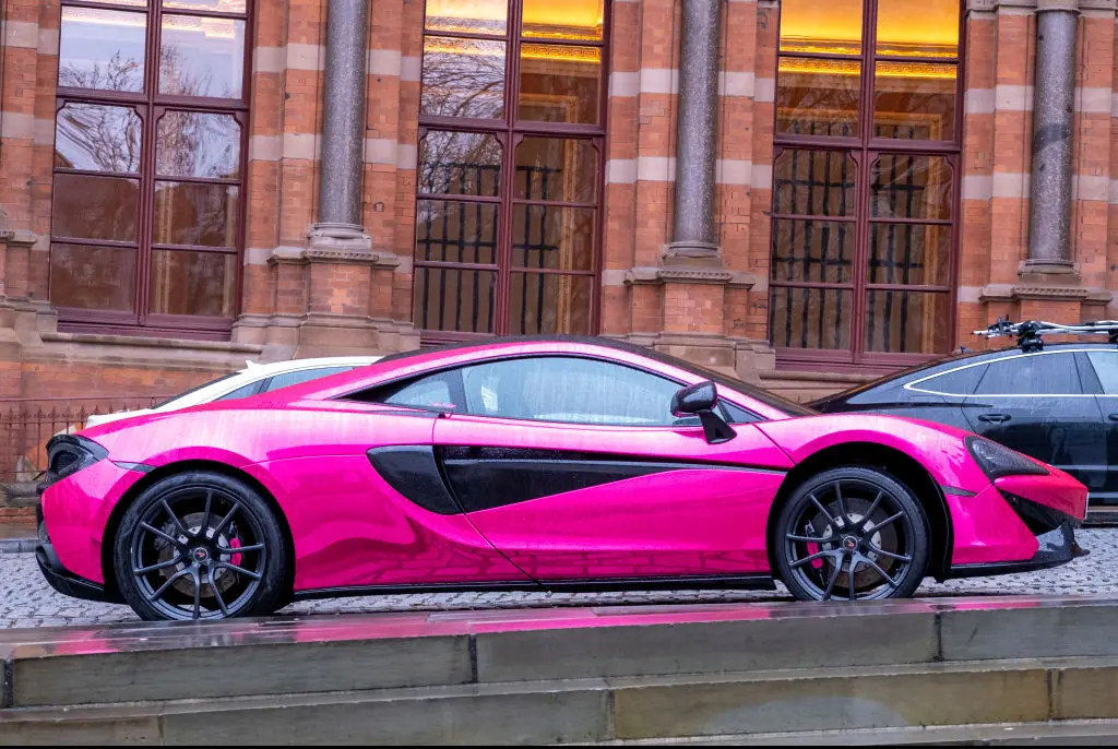 A pink McLaren 540c parked outside St Pancras Renaissance Hotel. Credit: Andrew Aitchison / Getty
