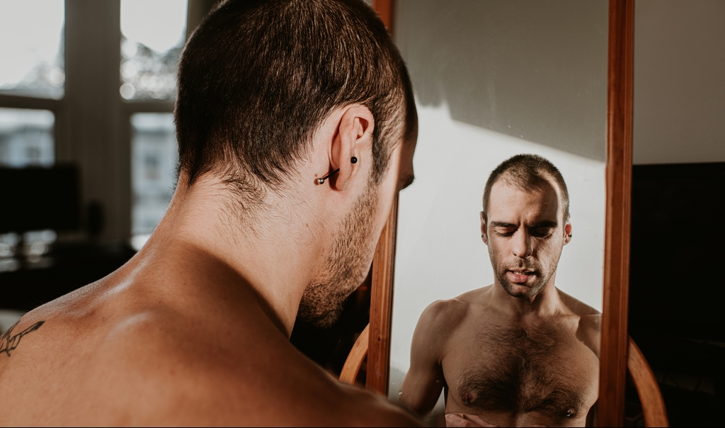 A man looking into a mirror.