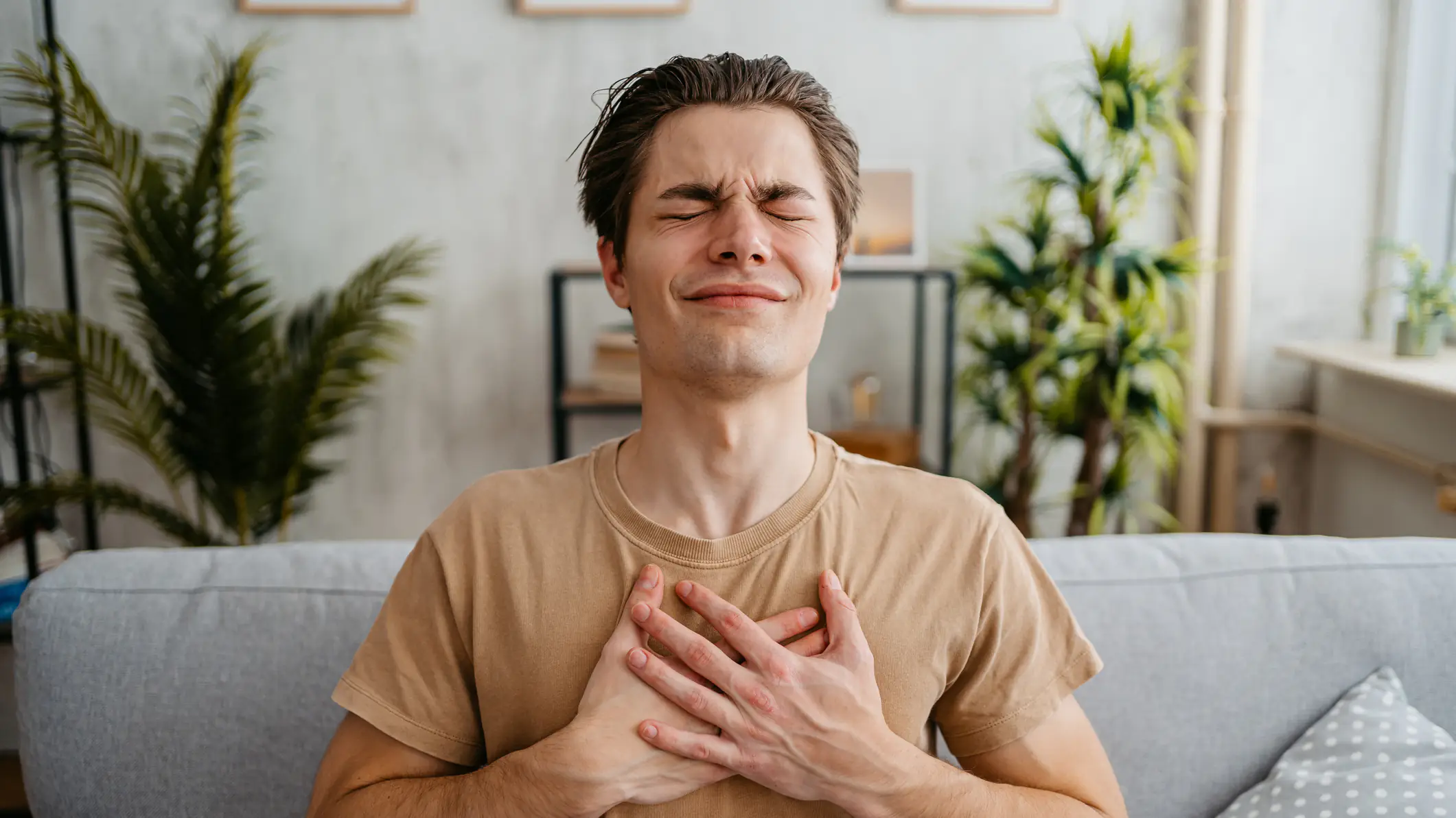 A man clutching his chest. (Heart)