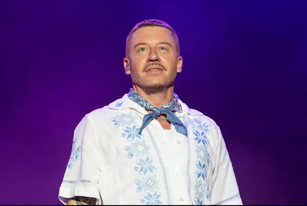 Macklemore invites excited fan onto stage, unknowingly leads to her arrest