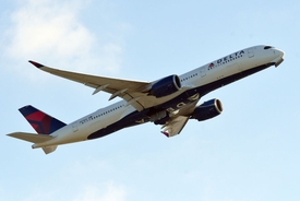 Flight attendant sits on the floor and holds nervous passenger's hand during flight