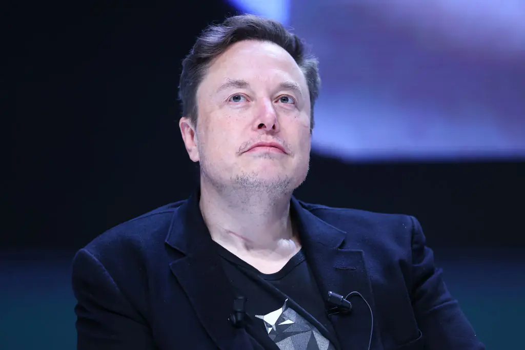 Elon Musk was 'playing with cutlery' while sitting next to Donald Trump. Credit: Marc Piasecki / Getty