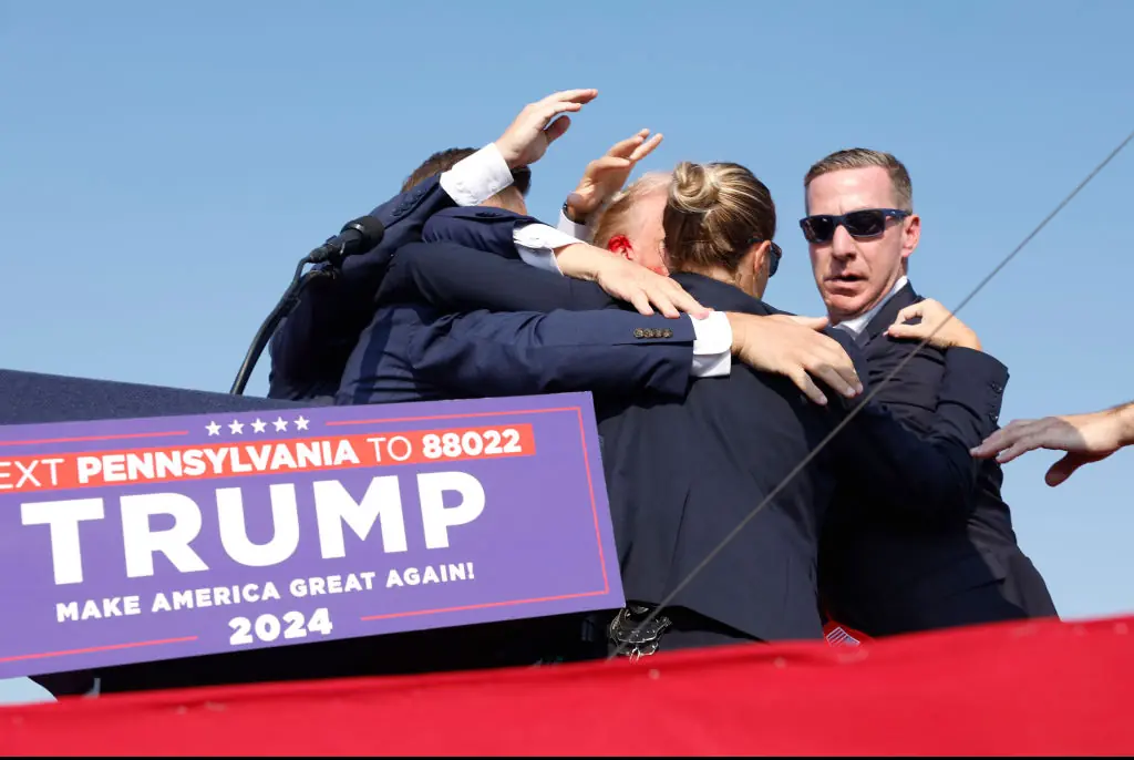 Donald Trump rushed off stage bleeding after gun attack at rally