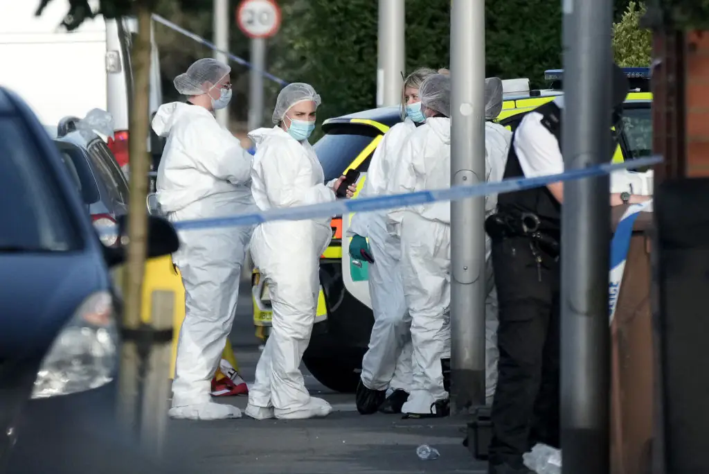 Police and forensic officers attend the scene of a multiple stabbing attack in Southport on Monday. Credit: Christopher Furlong/Getty