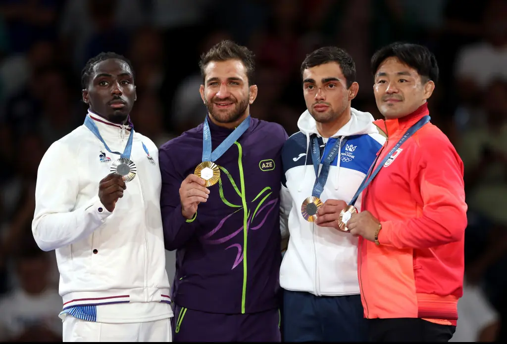 Gold medalist, Hidayat Heydarov of Team Azerbaijan (2L), Silver medalist, Joan-Benjamin Gaba of Team France (L), Bronze medalist A, Adil Osmanov of Team Republic of Moldova (2R) and Bronze Medalist B, Soichi Hashimoto of Team Japan (R) pose for a photo with their medal's during the Judo Men’s -73 kg medal ceremony. Credit: Alex Pantling/Getty