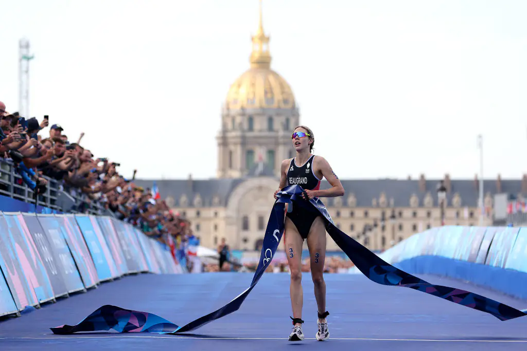 Cassandre Beaugrand of Team France crosses the finish tape to win the gold medal after competing in Women's Individual Triathlon. Credit: Michael Steele/Getty