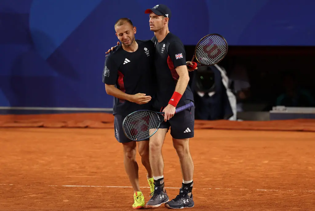 Andy Murray of Team Great Britain and partner Daniel Evans of Team Great Britain embrace after losing match point against Taylor Fritz of Team United States and Tommy Paul of Team United States. Credit: Julian Finney/Getty