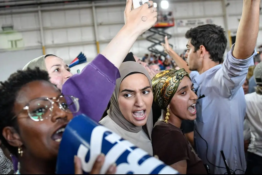 Protestors heckling Harris at her rally in Michigan. Credit: Adam J. Dewey/Anadolu/Getty