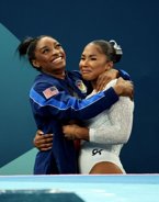Simone Biles and Sunisa Lee support Team USA's Jordan Chiles after she is stripped of bronze medal