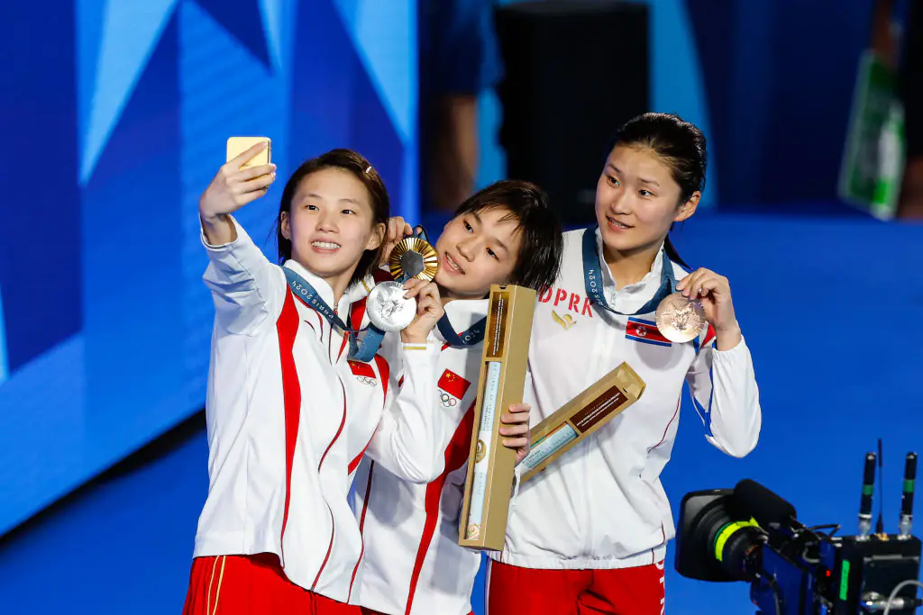 Silver medalist Yuxi Chen of People's Republic of Chinai, Gold medalist Quan Hongchan of People's Republic of China and Bronze medalist Kim Mi Rae of North Korea posed on the podium during the medal ceremony. Credit: Antonio Martinez/Europa Press/Getty