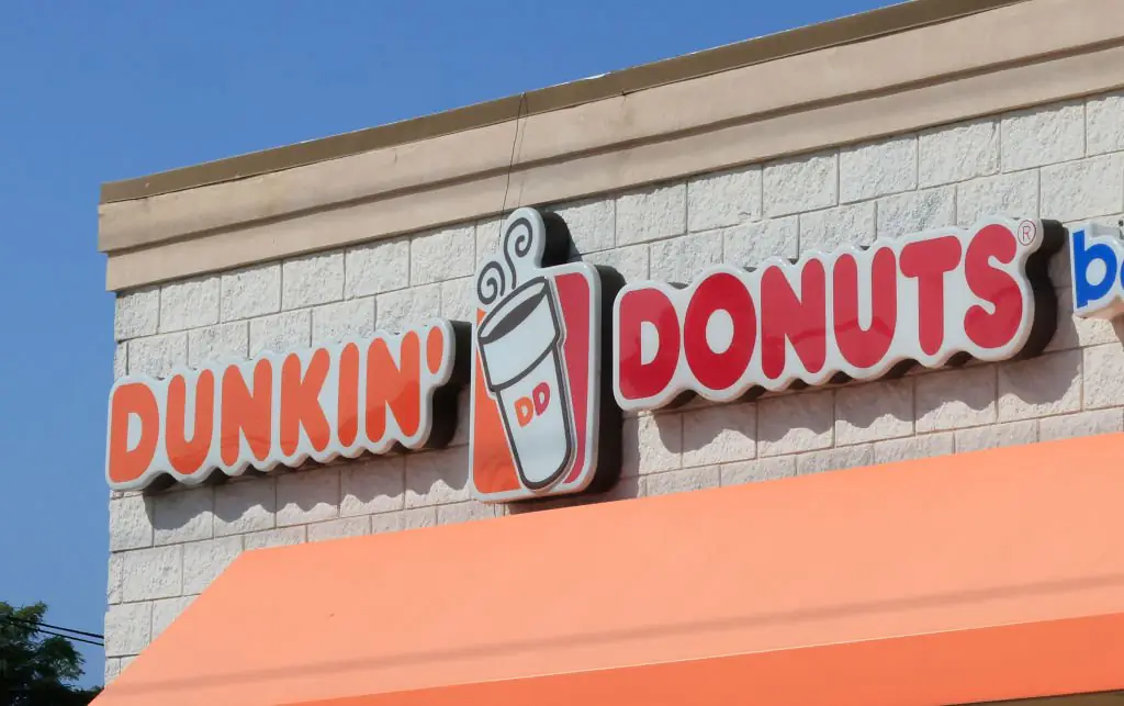 A Dunkin' Donuts employee has prompted outrage after being pictured with their feet out at work. Credit:	Bruce Bennett / Getty