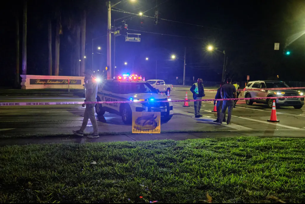 Authorities gather outside of the Trump International Golf Club. Credit: Anadolu / Getty