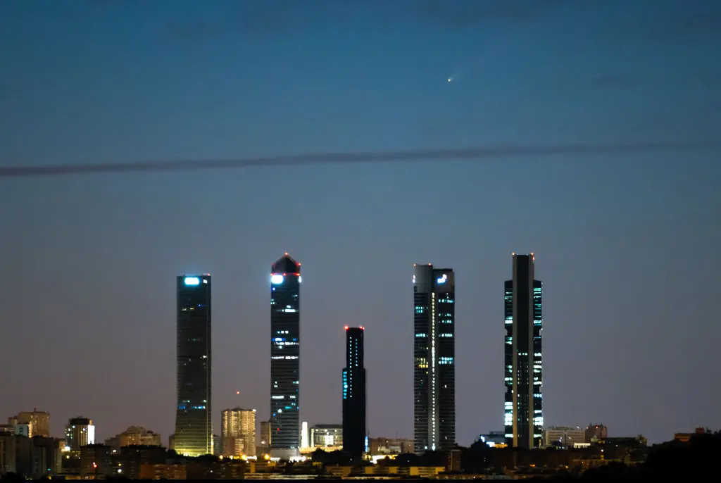 Comet C/2023 A3 (TsuchinshanATLAS) called also "the comet of the century" is seen crossing the sky over the skyscrapers of Madrid known as the Four Towers Business Area. Credit: Marcos del Mazo/LightRocket/Getty