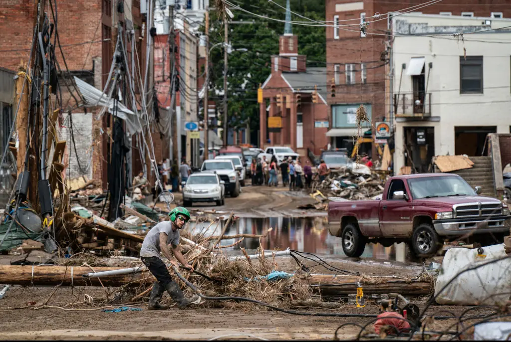 Workers, community members, and business owners clean up debris in the aftermath of Hurricane Helene in Marshall, North Carolina. Credit: Jabin Botsford/The Washington Post/Getty