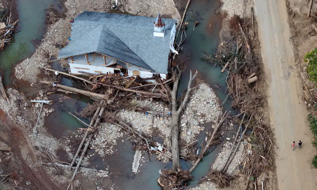 An aerial view shows people walking past a destroyed church in North Carolina in the aftermath of Hurricane Helene. Credit: Mario Tama/Getty