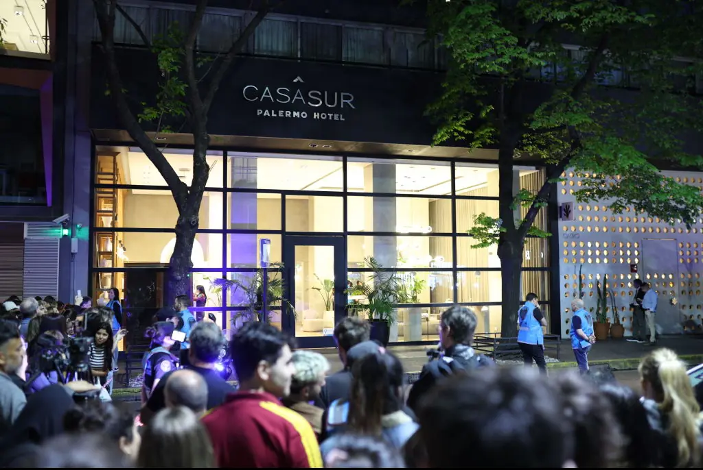 People gathered outside of the Casasur Palermo Hotel. Credit: Tobias Skarlovnik/Getty