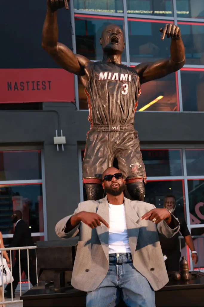 Dwyane Wade with his statue. Credit: Carmen Mandato/Getty