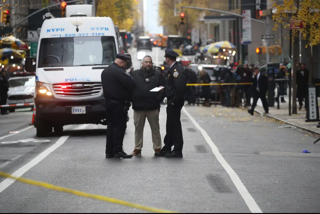 Police gather outside of a Hilton Hotel in Midtown Manhattan where United Healthcare CEO Brian Thompson was fatally shot. Credit: Spencer Platt/Getty 