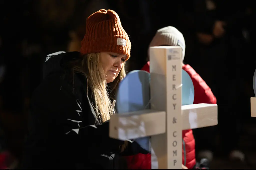 People leave messages on crosses during a vigil on the grounds of the state Capital building to mourn the victims of the shooting at Abundant Life Christian School . Credit: Scott Olson/Getty 