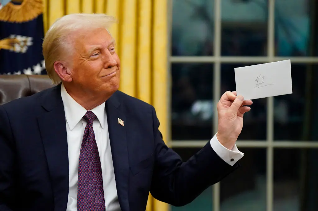 Trump holds up the letter from Biden. Credit:  Jabin Botsford /The Washington Post via Getty Images
