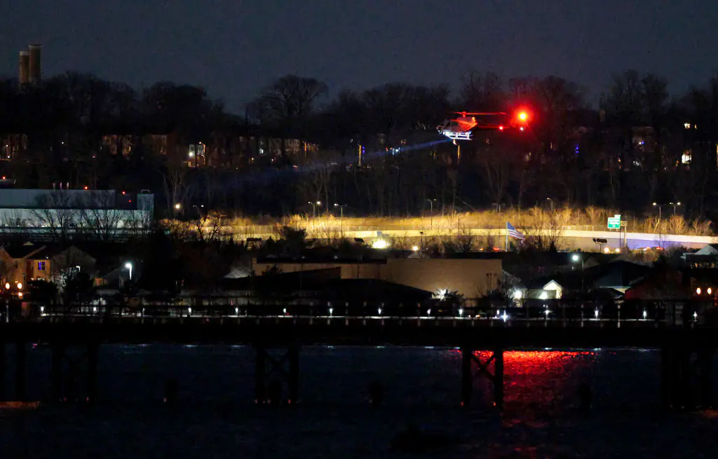 A helicopter assists with search and rescue operations over the Potomac River near Ronald Reagan Washington Airport. Credit: Chip Somodevilla/Getty Images