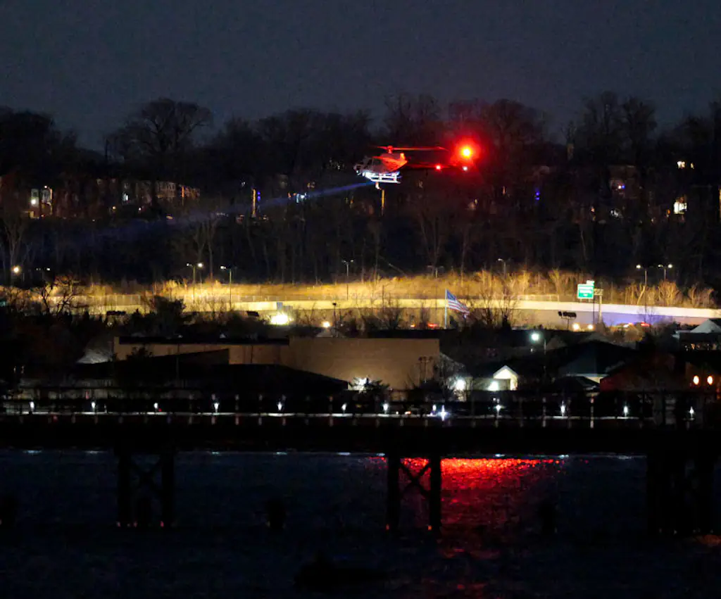 A helicopter assists with search and rescue operations over the Potomac River near Ronald Reagan Washington Airport. Credit: Chip Somodevilla/Getty Images