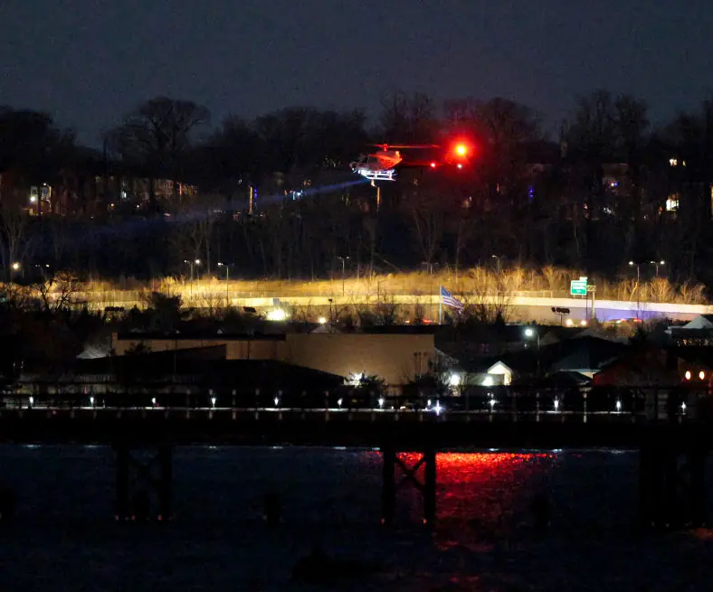 A helicopter assists with search and rescue operations over the Potomac River near Ronald Reagan Washington Airport. Credit: Chip Somodevilla/Getty Images