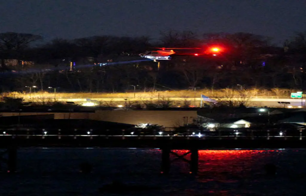 A helicopter assists with search and rescue operations over the Potomac River near Ronald Reagan Washington Airport. Credit: Chip Somodevilla/Getty Images