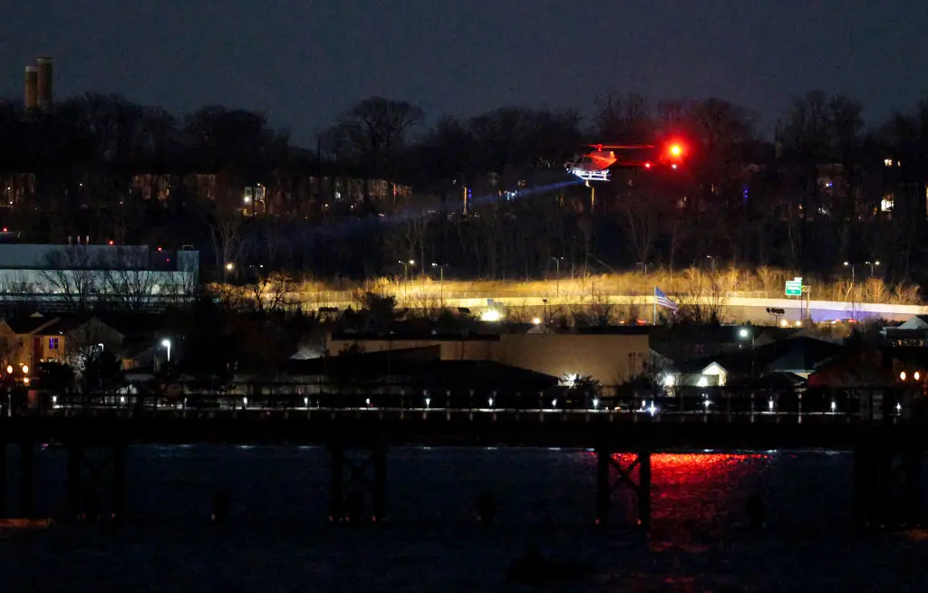 A helicopter assists with search and rescue operations over the Potomac River near Ronald Reagan Washington Airport. Credit: Chip Somodevilla/Getty Images