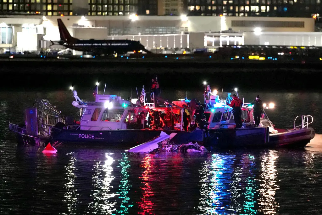  Emergency divers respond after a passenger aircraft collided with a helicopter. Credit: Andrew Harnik / Getty