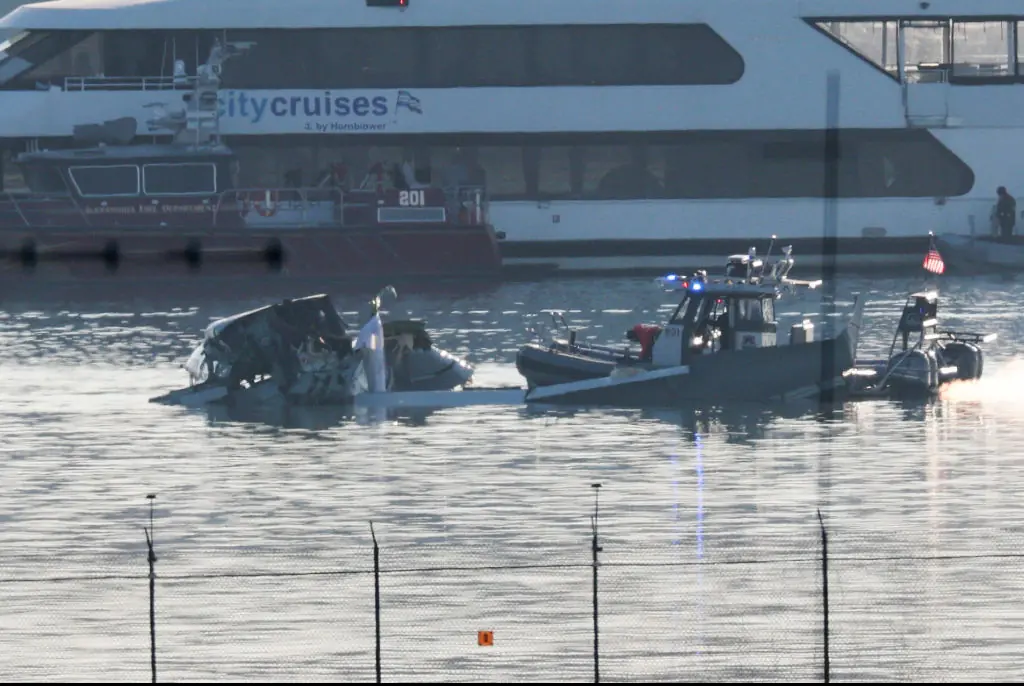 Recovery teams pulling the wreckage from the river. Credit: Win McNamee / Getty