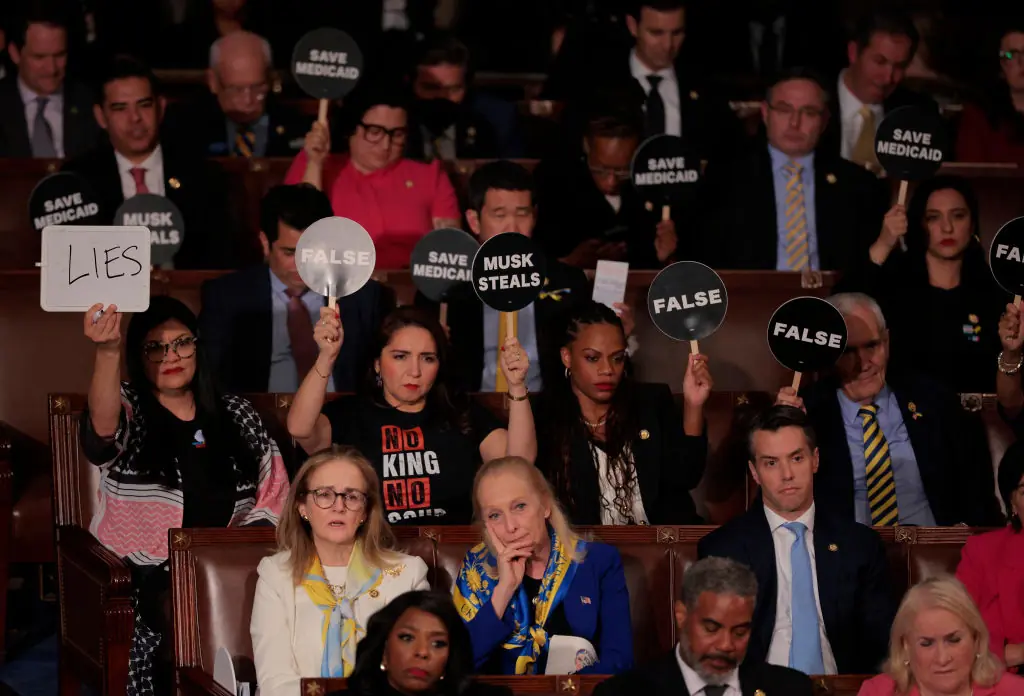 Democratic members of Congress hold up signs in protest. Credit:	Chip Somodevilla / Getty