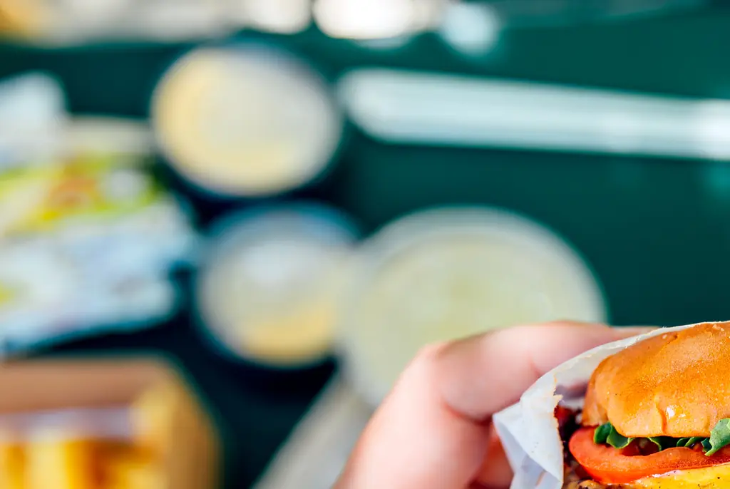 Food influencers hit by a car while reviewing a burger inside restaurant
