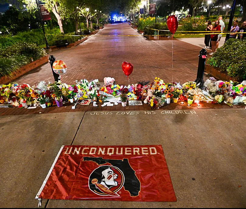 Flowers and tributes laid on campus grounds. Credit: Miguel J. Rodriguez Carrillo / Getty
