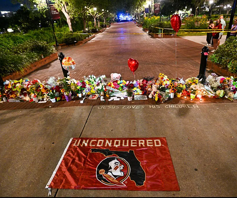 Flowers and tributes laid on campus grounds. Credit: Miguel J. Rodriguez Carrillo / Getty