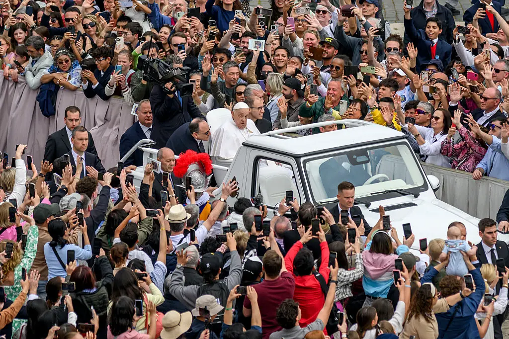 The Pope drove through the crowds in the Popemobile, stopping to bless babies and children. Credit: Antonio Masiello/Getty Images