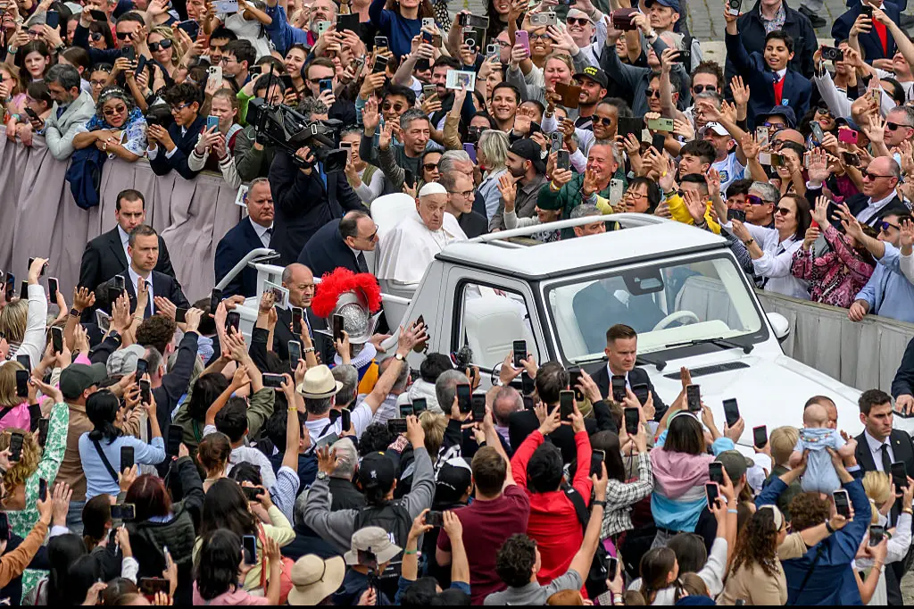The Pope drove through the crowds in the Popemobile, stopping to bless babies and children. Credit: Antonio Masiello/Getty Images