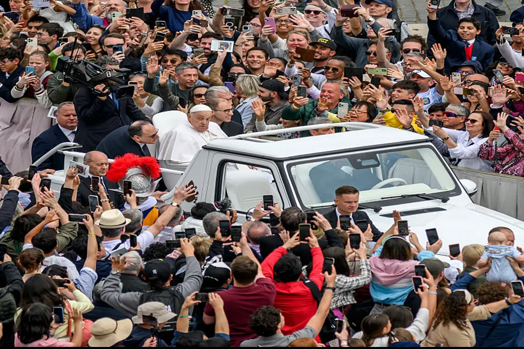 The Pope drove through the crowds in the Popemobile, stopping to bless babies and children. Credit: Antonio Masiello/Getty Images