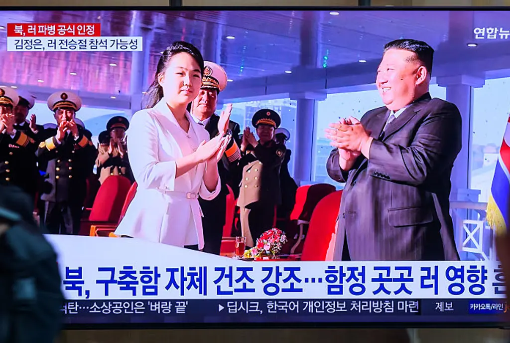Seoul Railway Station showing a news broadcast with the Kim Jong Un and his daughter attending a launch ceremony. Credit: SOPA Images / Getty