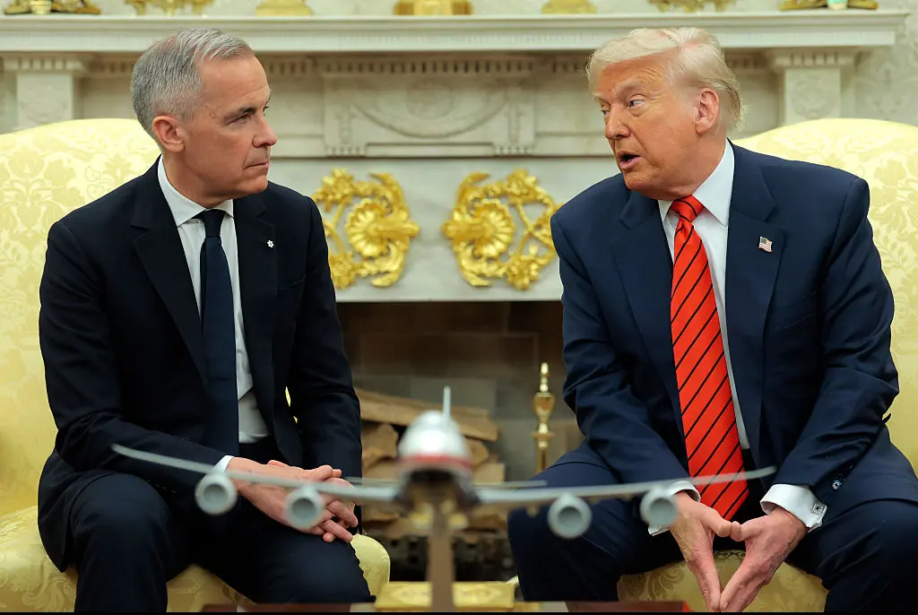 U.S. President Donald Trump speaks to reporters alongside Canadian Prime Minister Mark Carney in the Oval Office. Credit: Anna Moneymaker / Getty