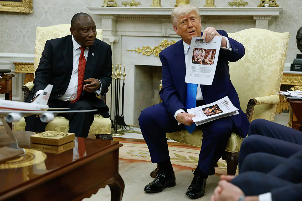 Trump holding up the printed articles. Credit: Chip Somodevilla/Getty Images