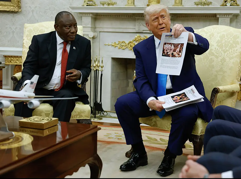 Trump holding up the printed articles. Credit: Chip Somodevilla/Getty Images