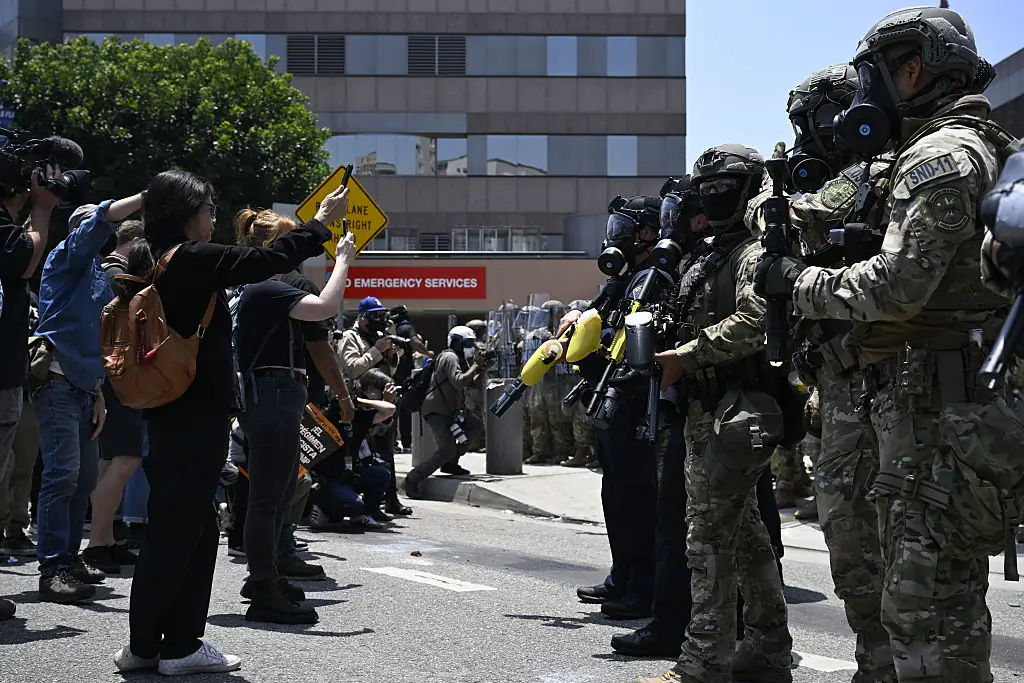 ICE officers and national guards confront with protesters outside of the Metropolitan Detention Center in LA. Credit: Tayfun Coskun/Anadolu via Getty Images