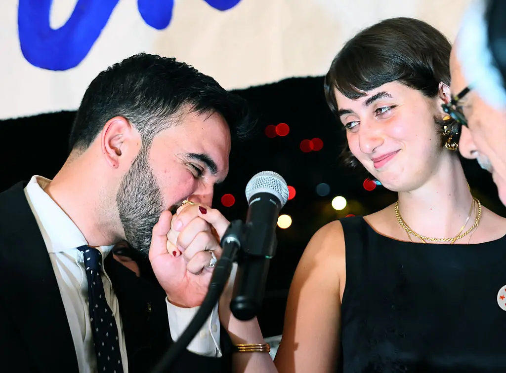 Zohran Mamdani kisses the hand of his wife Rama Duwaji. Credit: Michael M. Santiago / Getty Images.