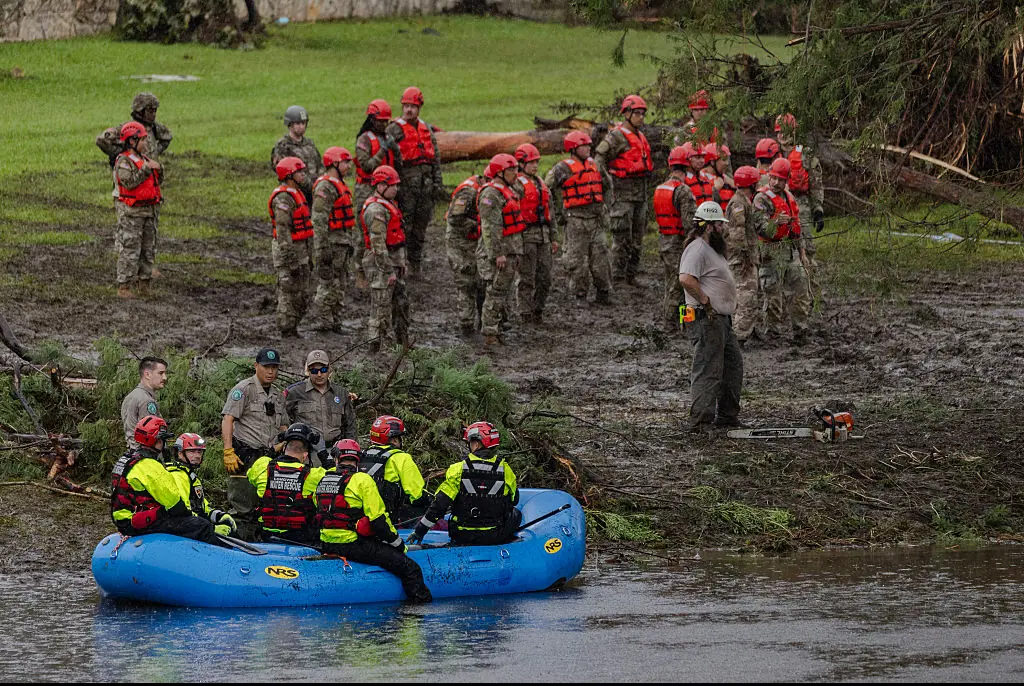 Search and recovery workers dig through debris looking for any survivors or remains of people swept up in the flash flooding at Camp Mystic. Credit: Jim Vondruska / Getty Images.